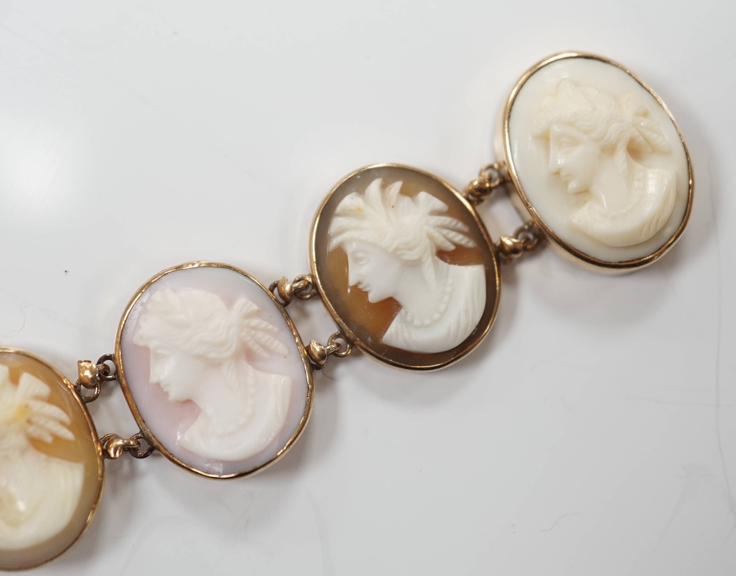 A yellow metal mounted ten stone oval cameo shell set bracelet, each carved with bust of a lady to sinister, 16cm, gross weight 13.9 grams.